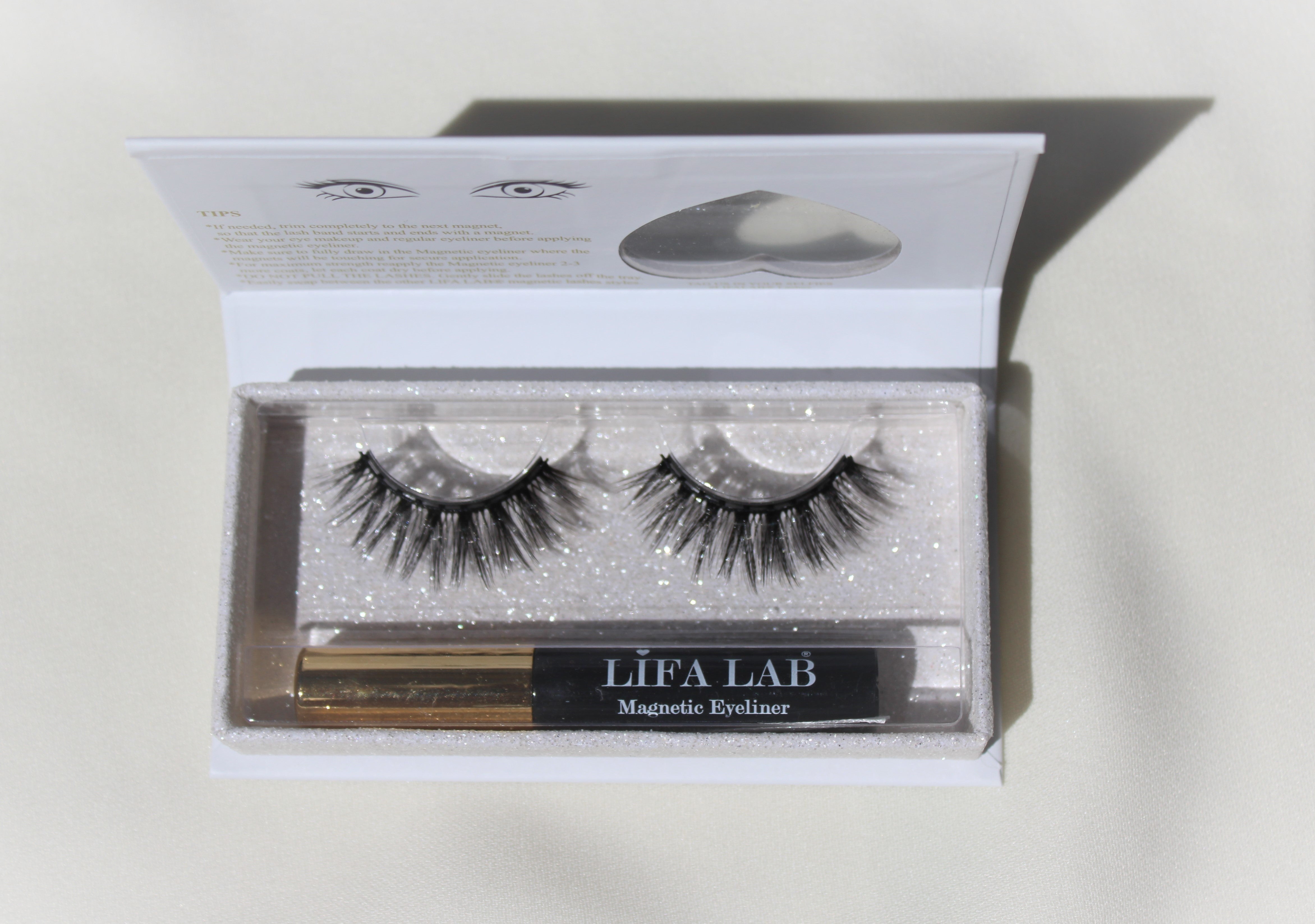 chic and magnificent Magnetic long salon eyelash from natural fibre with a magnetic black and gold eyeliner in a luxury box with a heart window on a white table cloth